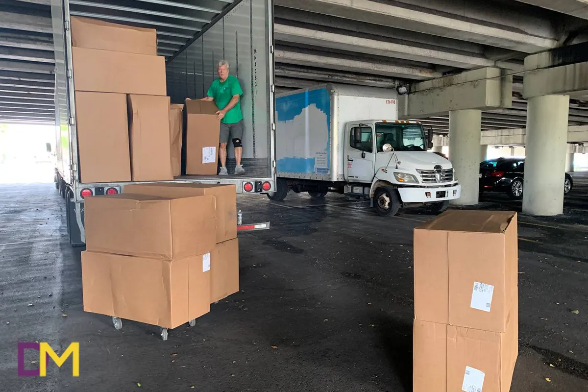 Team Member Loading Boxes in White Truck Doral Moving Team Member Loading Boxes in White Truck