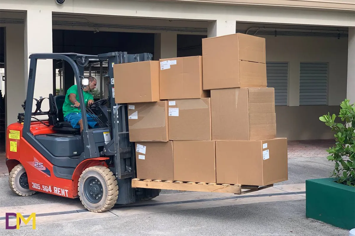 Team Member Loading Boxes on Red Loader Doral Moving Team Member Loading Boxes on Red Loader